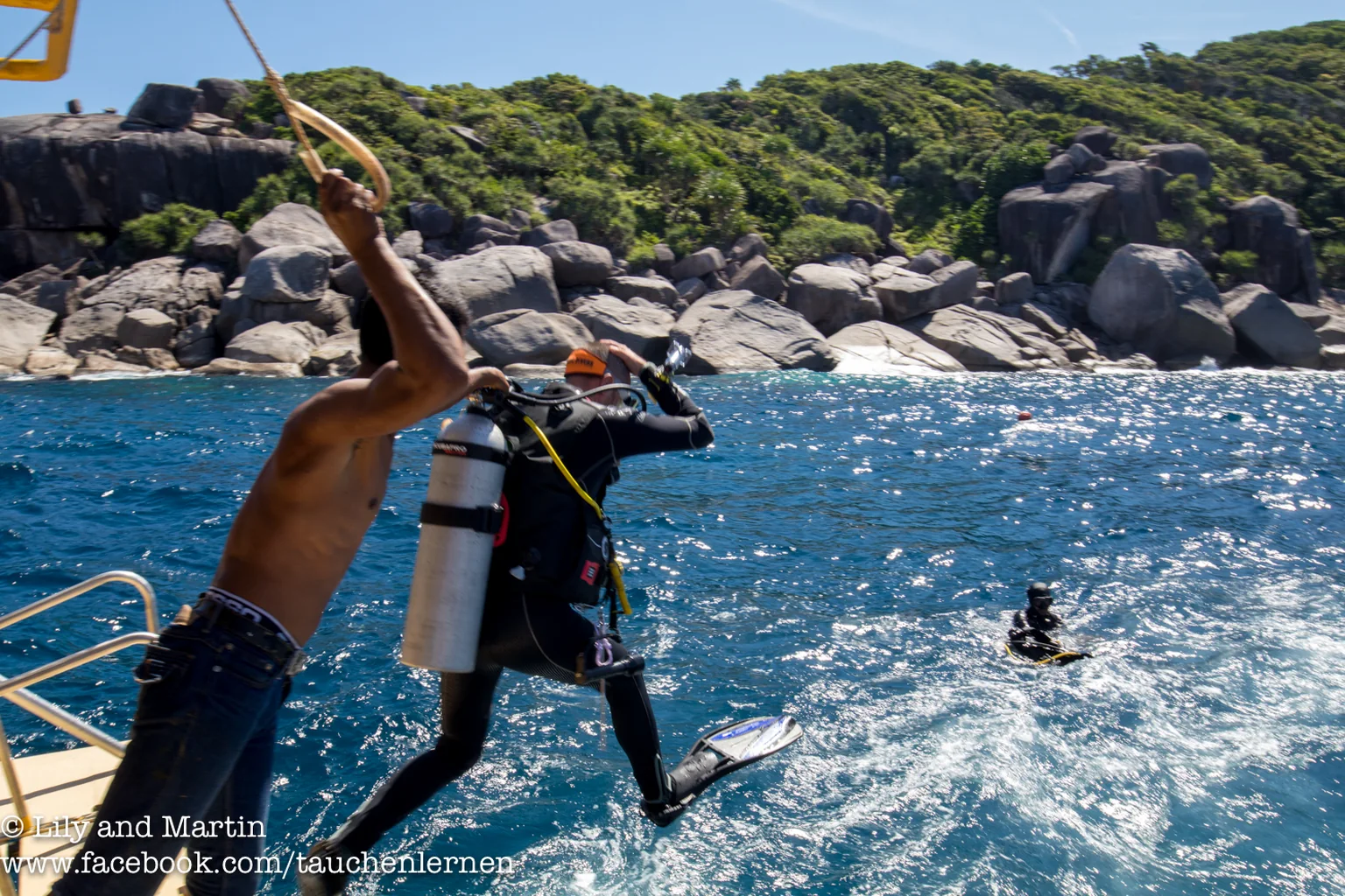 Scuba diver stepping from a dive boat into the water